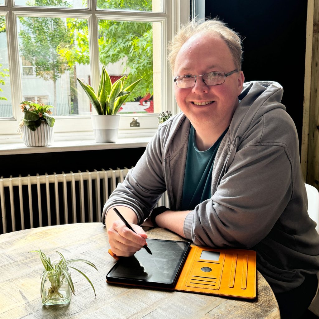 Photograph of Matt sitting at a desk