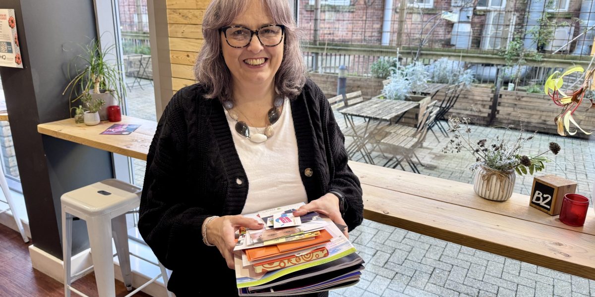 Sian holding various printed items